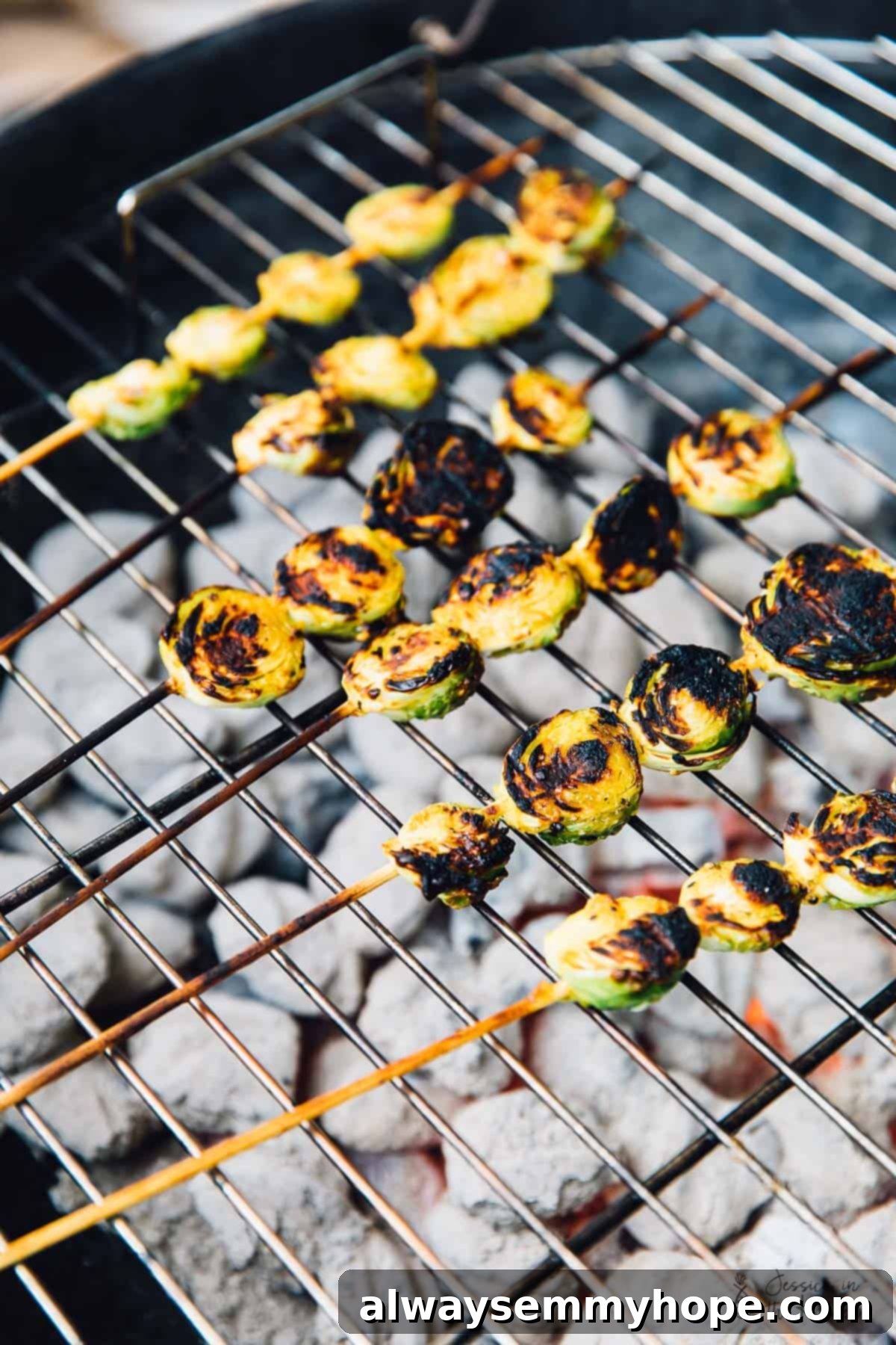 Skewers of maple mustard brussels sprouts on a bbq grill. 