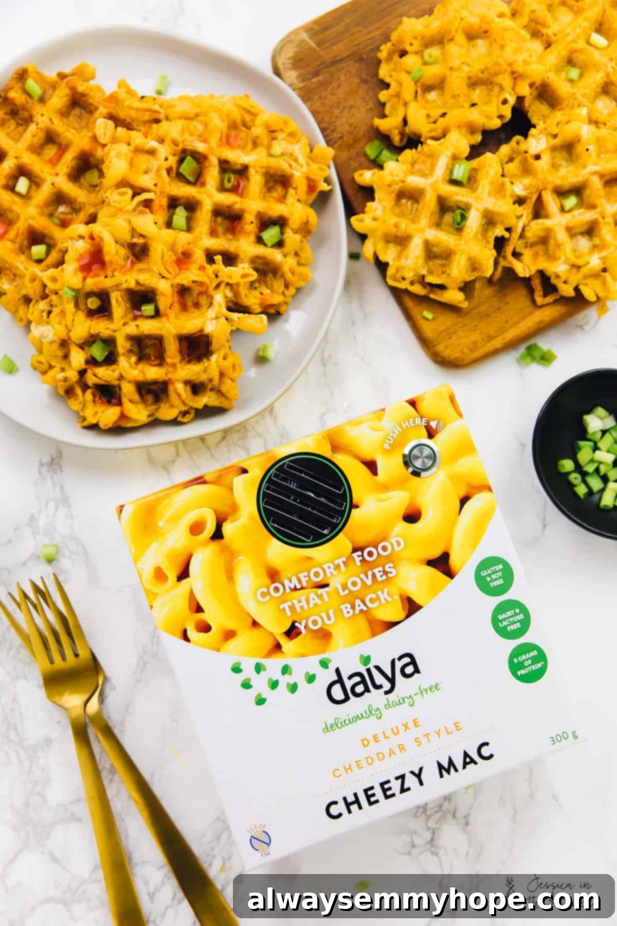 Top down view of crispy mac and cheese waffles on a plate with a pack of mac and cheese in the background.