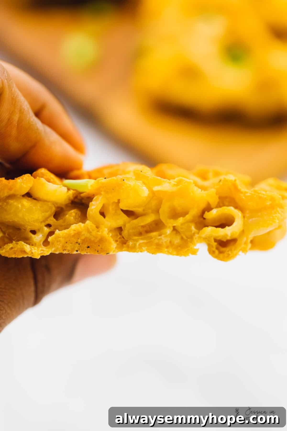 Side shot of a crispy mac and cheese waffle.