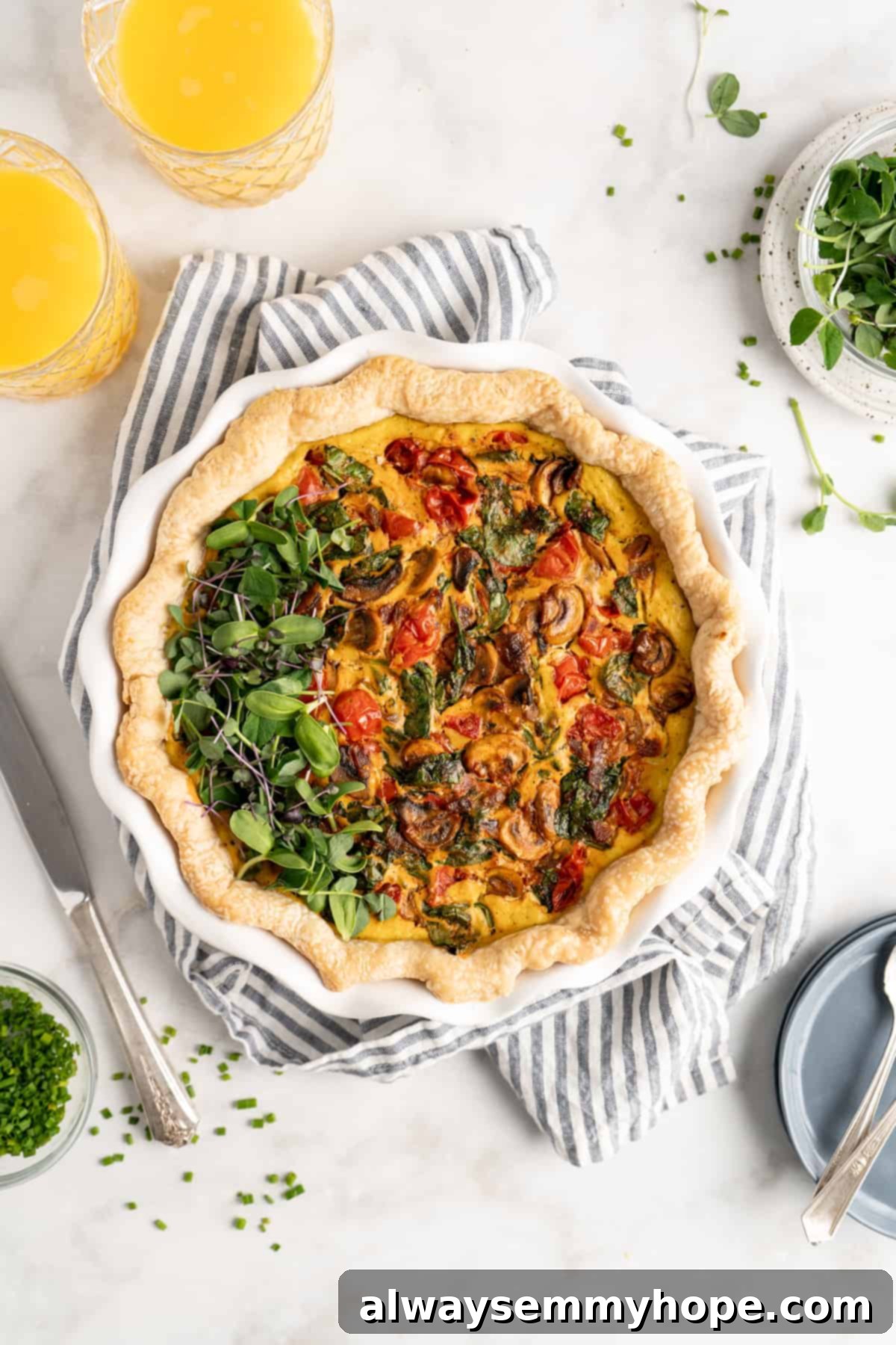 An overhead view of a freshly baked vegan vegetable quiche, perfectly golden brown, adorned with a sprinkling of fresh green herbs, signaling it's ready to be served.