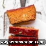 Overhead view of vegan meatloaf cut into slices on a parchment-lined wire rack.