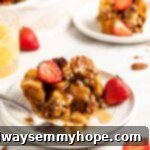 Overnight French Toast Casserole on plate with fresh strawberries