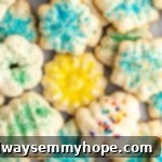 Overhead view of a pile of spritz cookies covered in different colors of sprinkles