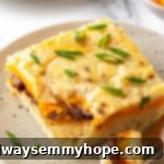 Piece of biscuits and gravy casserole on plate with fork
