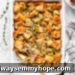vegan stuffing in a casserole dish with a spoon and a scoop taken out