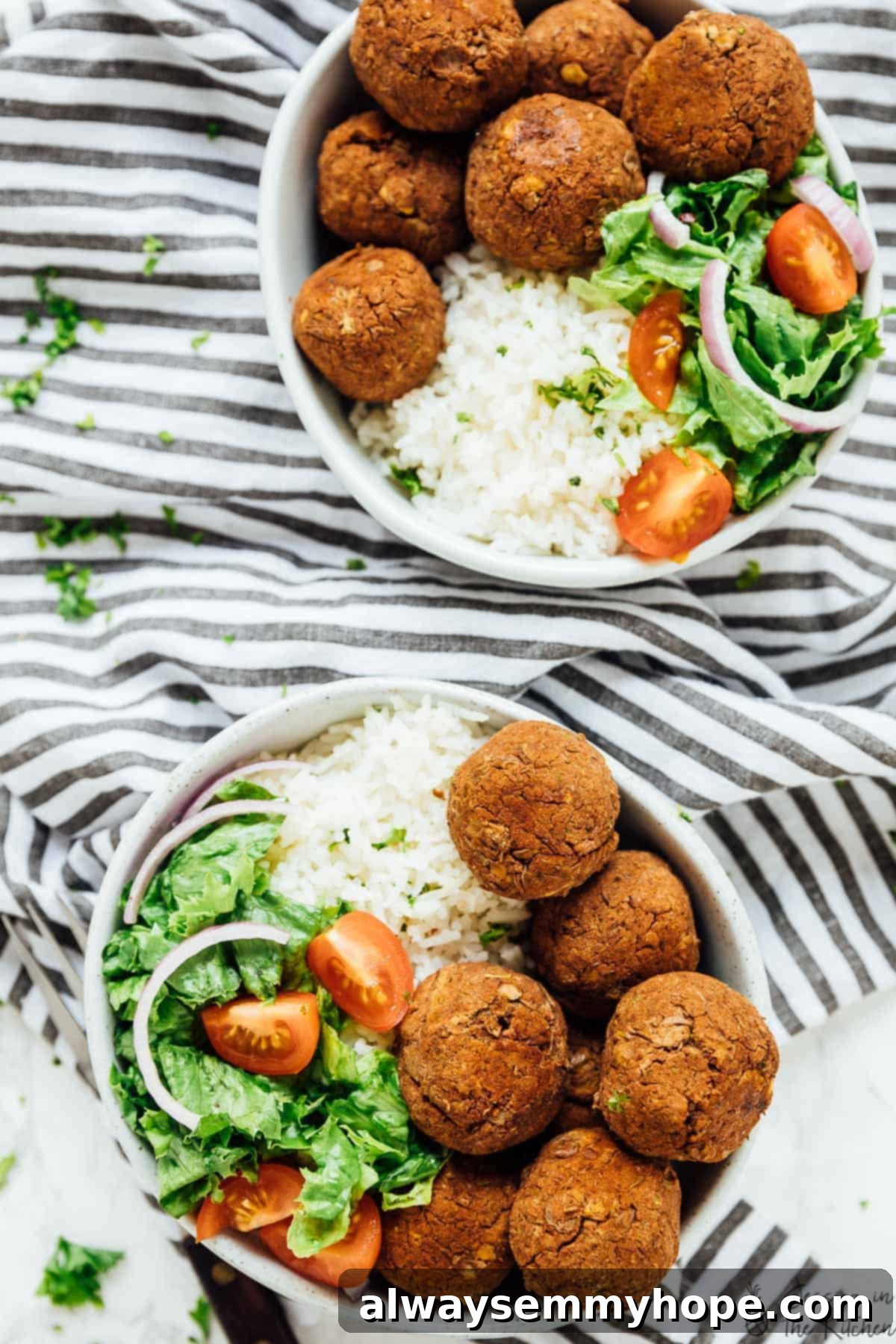 Overhead view showcasing two beautifully plated bowls of vegan lentil balls with vibrant zesty rice and fresh garnishes.