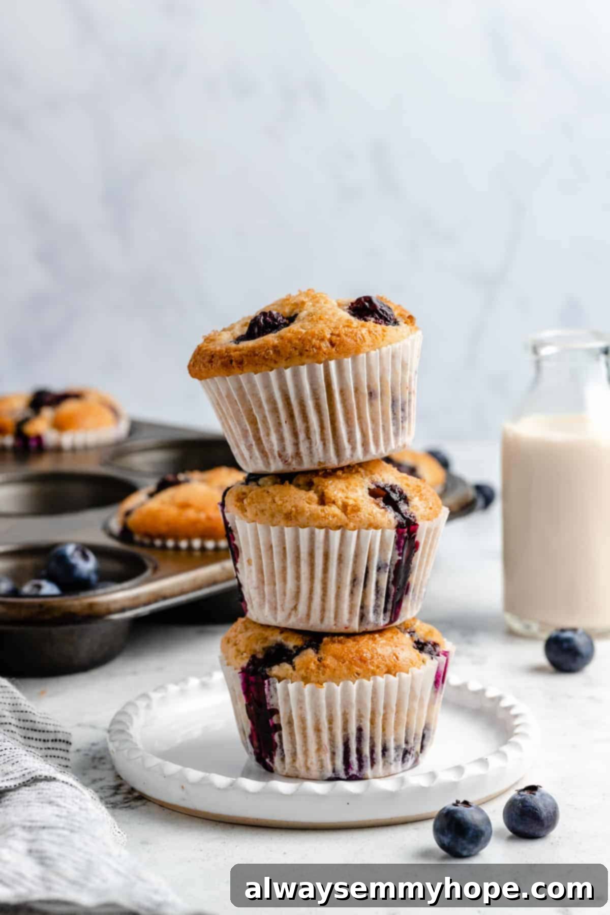 What is cassava flour? And how can you use it in gluten-free baking? I break down everything you need to know about cassava flour. Three stacked blueberry muffins on a plate.