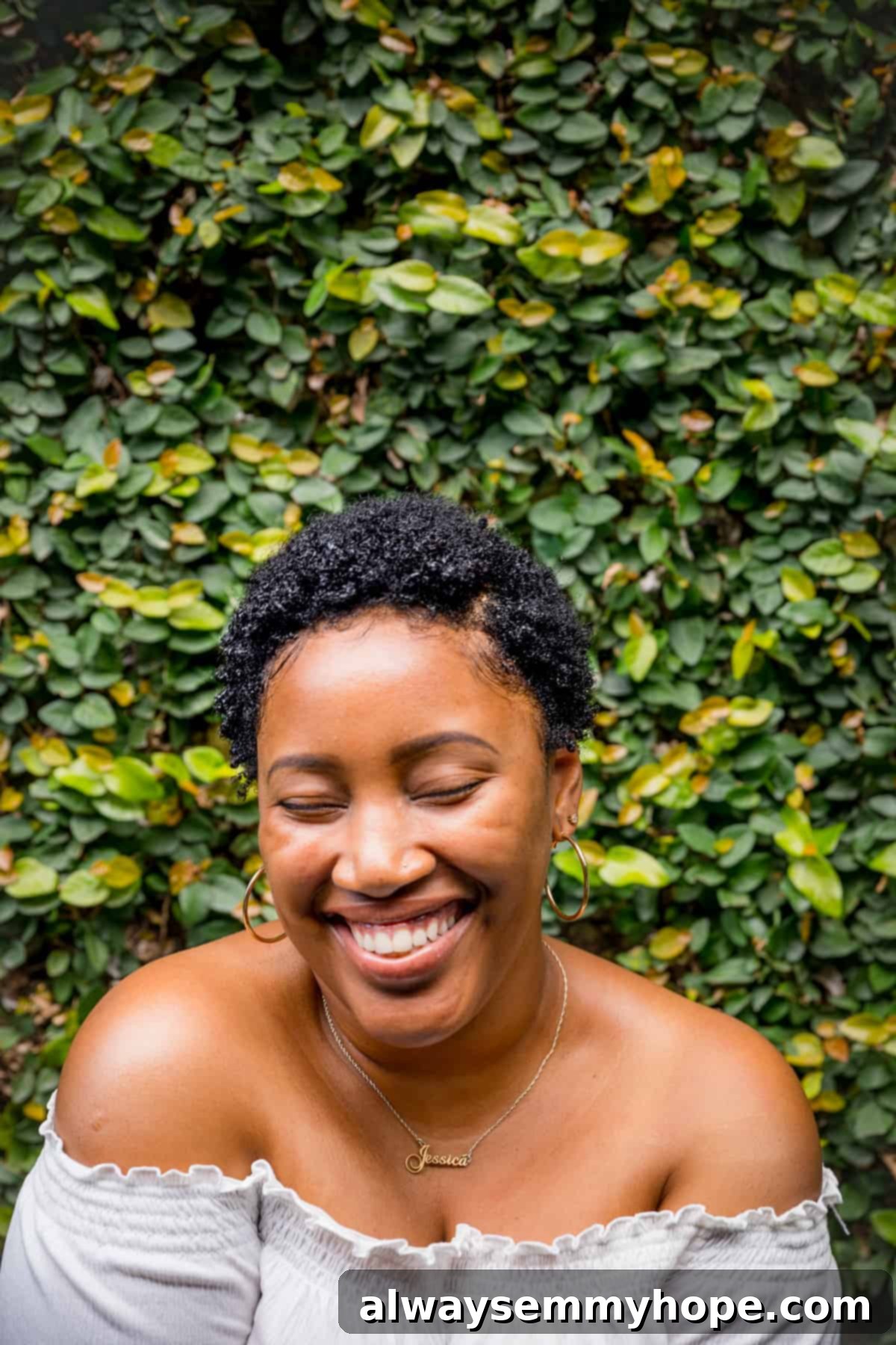 Simplify Your New Year's Goals 3 Woman laughing, in front of a bush.