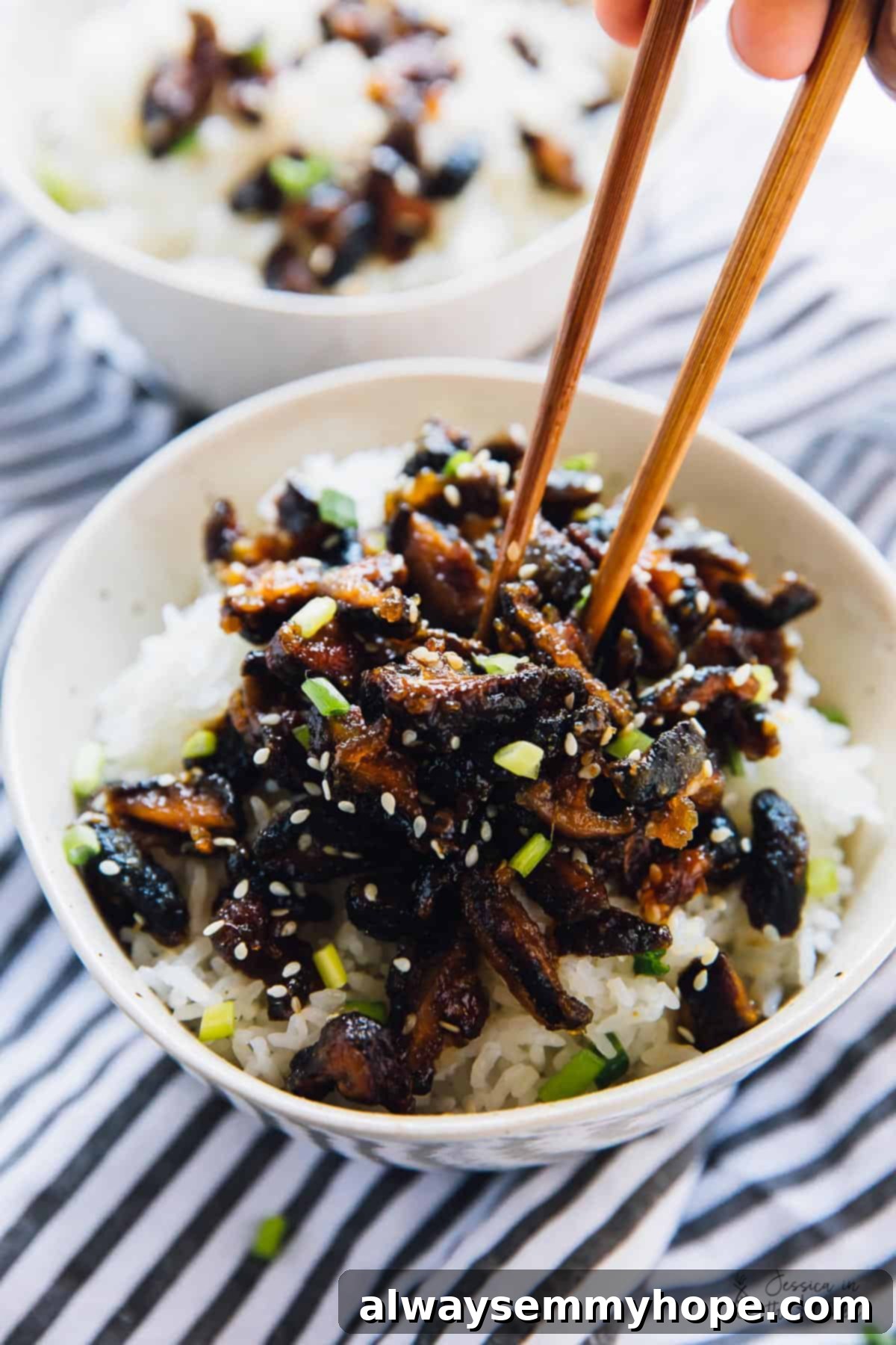 10 Quick & Easy Vegan Fakeaway Recipes 3 Chopsticks digging into a bowl of sticky sesame shiitake mushrooms for a roundup on Vegan Takeout Recipes.