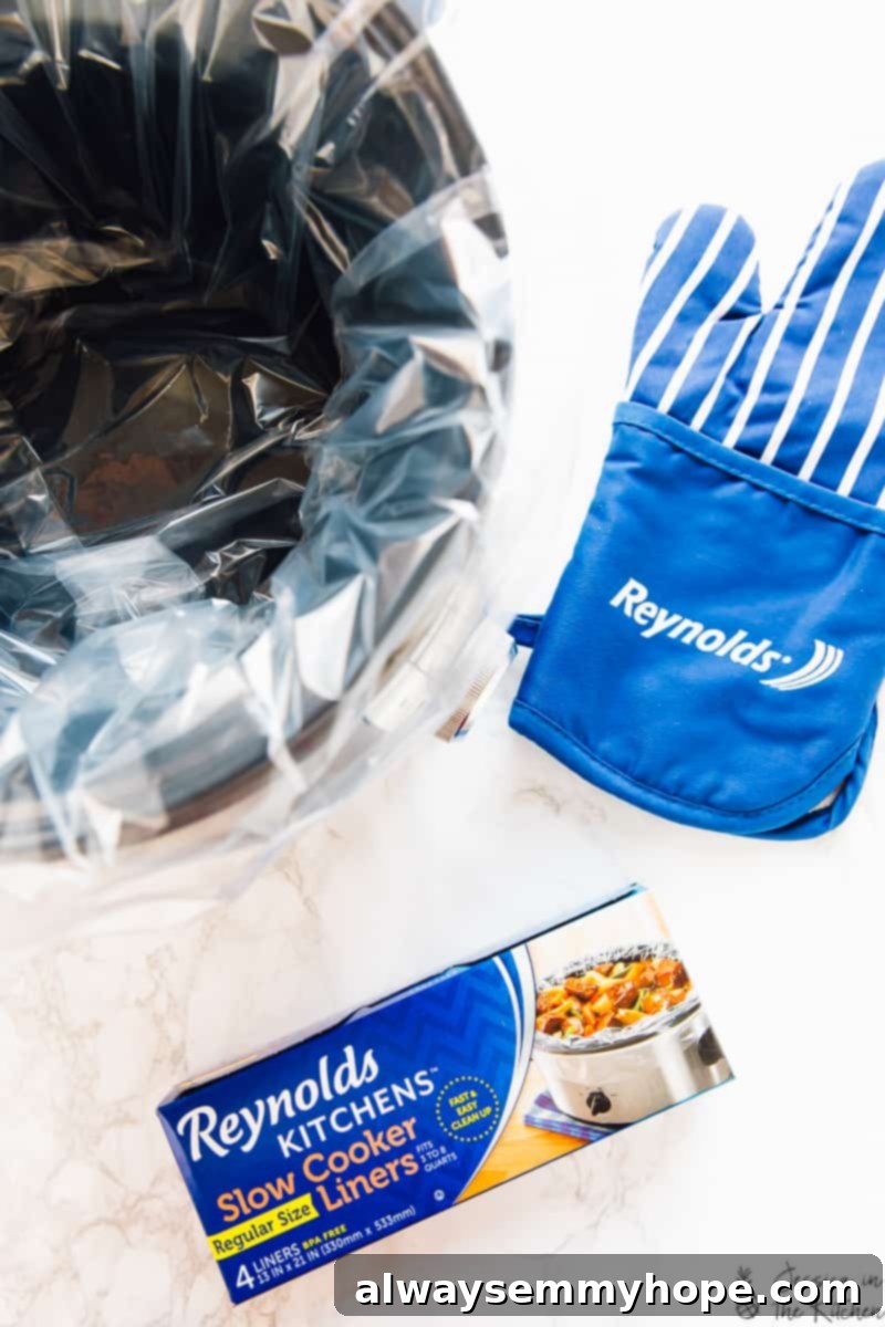 Slow Cooker Vegan Tofu Butter Chicken 2 A modern slow cooker sits next to a package of Reynolds Kitchens Slow Cooker Liners, highlighting convenient cooking.