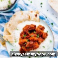 Slow Cooker Vegan Tofu Butter Chicken 7 Overhead view of slow cooker tofu butter chicken on a plate with rice on the side, ready to be served.