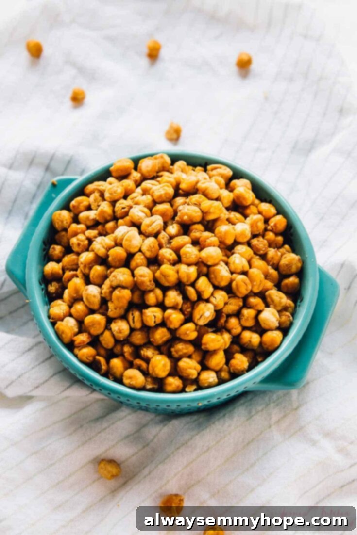 A bowl of perfectly golden-brown crispy roasted chickpeas, seasoned with spices, ready for healthy snacking.