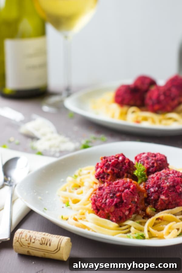 Rich and vibrant chickpea and beet vegan meatballs, perfectly shaped and ready to be served over pasta with a flavorful sauce.