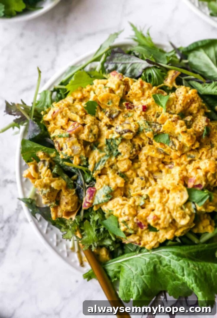A vibrant and flavorful curried chickpea salad, presented beautifully for a quick and healthy meal, garnished with fresh herbs.