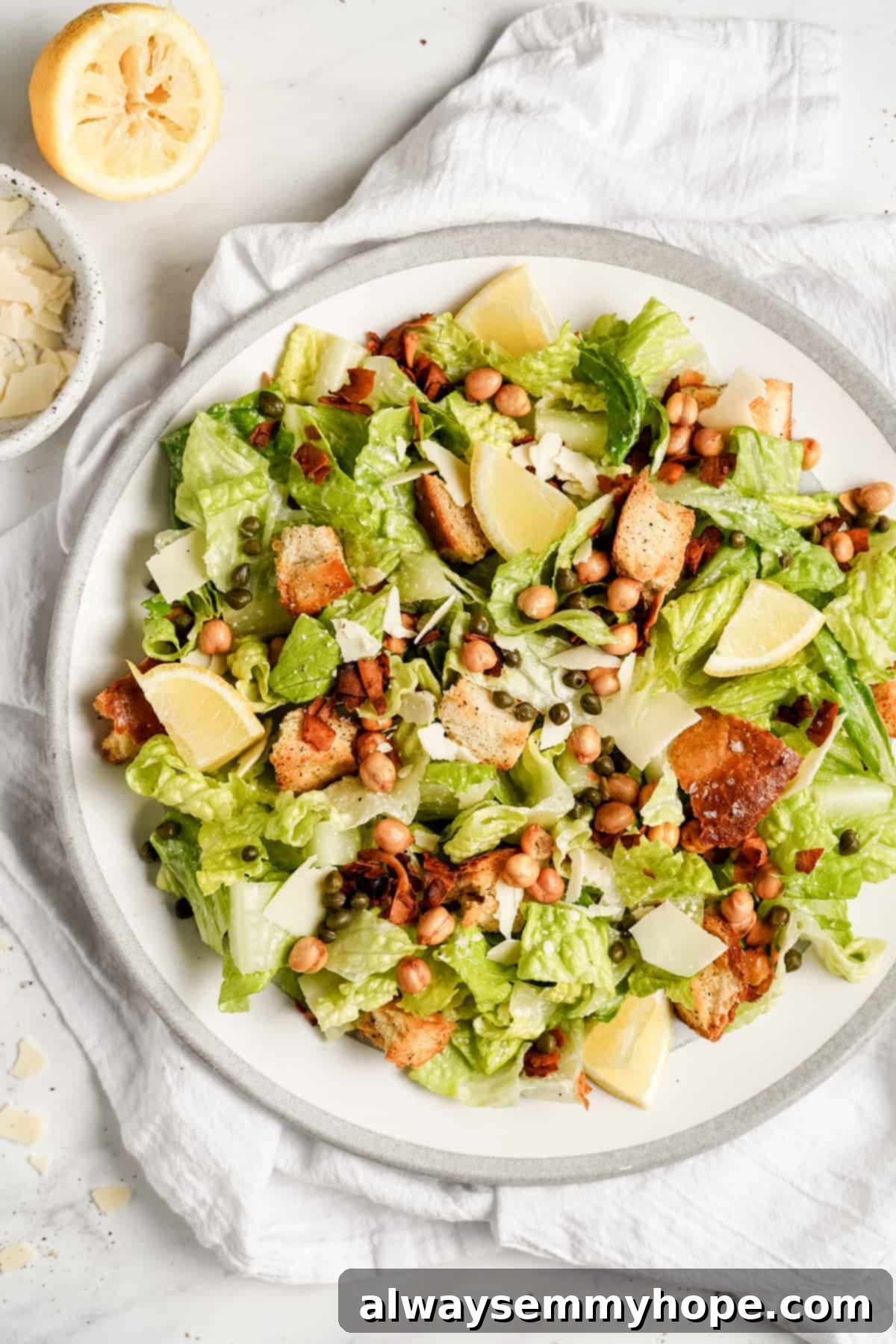 Vegan Caesar salad is perfect as a quick side dish or a light dinner! It’s made with a tangy dressing, crunchy croutons, and crisp lettuce. A close-up of a serving of vegan Caesar salad, showcasing the creamy dressing, crispy croutons, and vegan Parmesan, ready to be enjoyed.