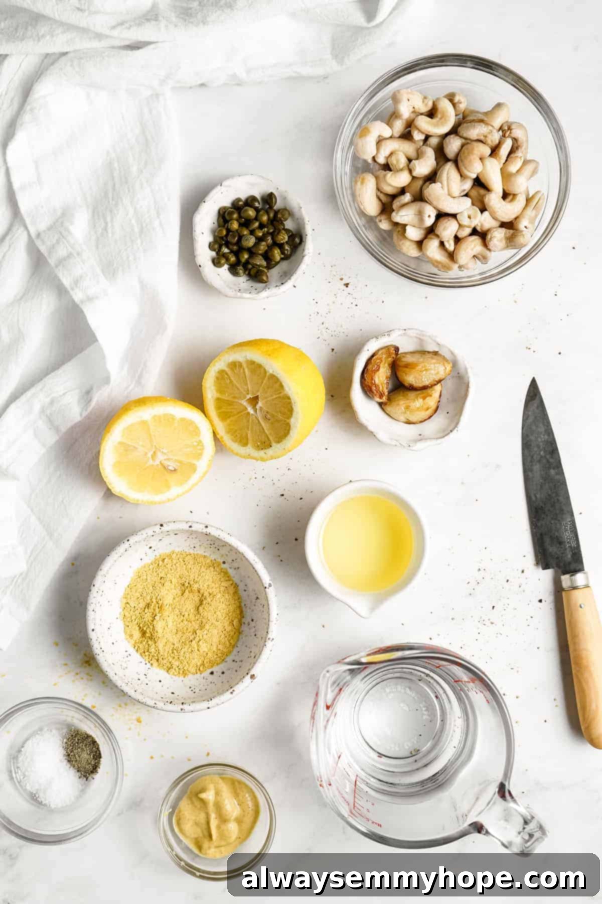 Vegan Caesar salad is perfect as a quick side dish or a light dinner! It’s made with a tangy dressing, crunchy croutons, and crisp lettuce. A vibrant display of fresh ingredients for vegan Caesar salad dressing, including lemons, garlic, tahini, and capers, perfectly arranged for blending.
