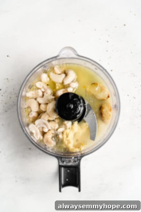 Vegan Caesar salad is perfect as a quick side dish or a light dinner! It’s made with a tangy dressing, crunchy croutons, and crisp lettuce. Lemon juice, water, and other vegan Caesar dressing ingredients are being added to a blender, preparing for a creamy blend.