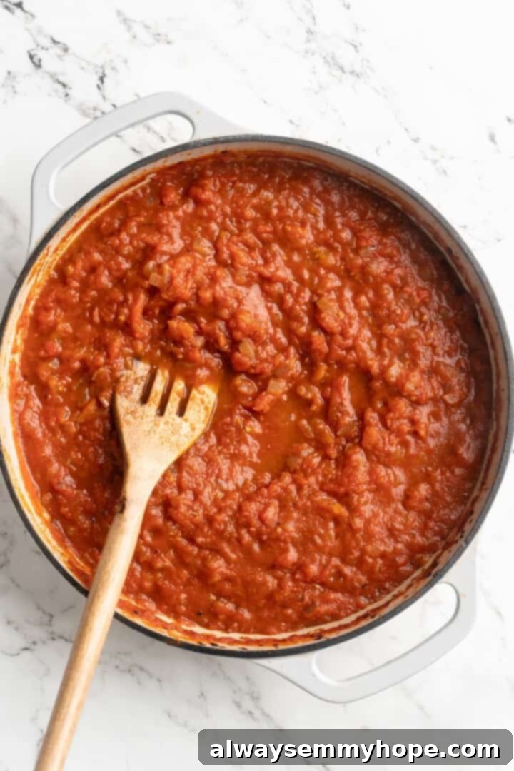 Overhead view of arrabbiata sauce after simmering for 30 minutes, now thickened and rich red.