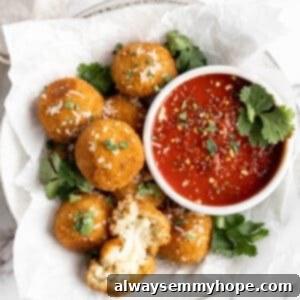 Vegan Arancini Fried Rice Balls Fry or Air Fry 2 Vegan arancini in parchment-lined bowl with marinara sauce