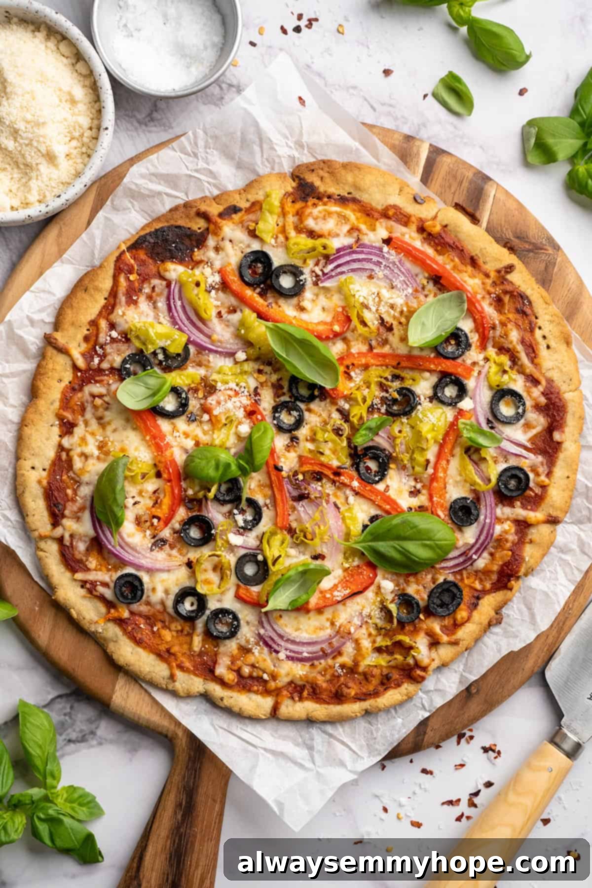 Overhead view of a perfectly baked vegetable pizza with almond flour crust, sliced and ready to serve.