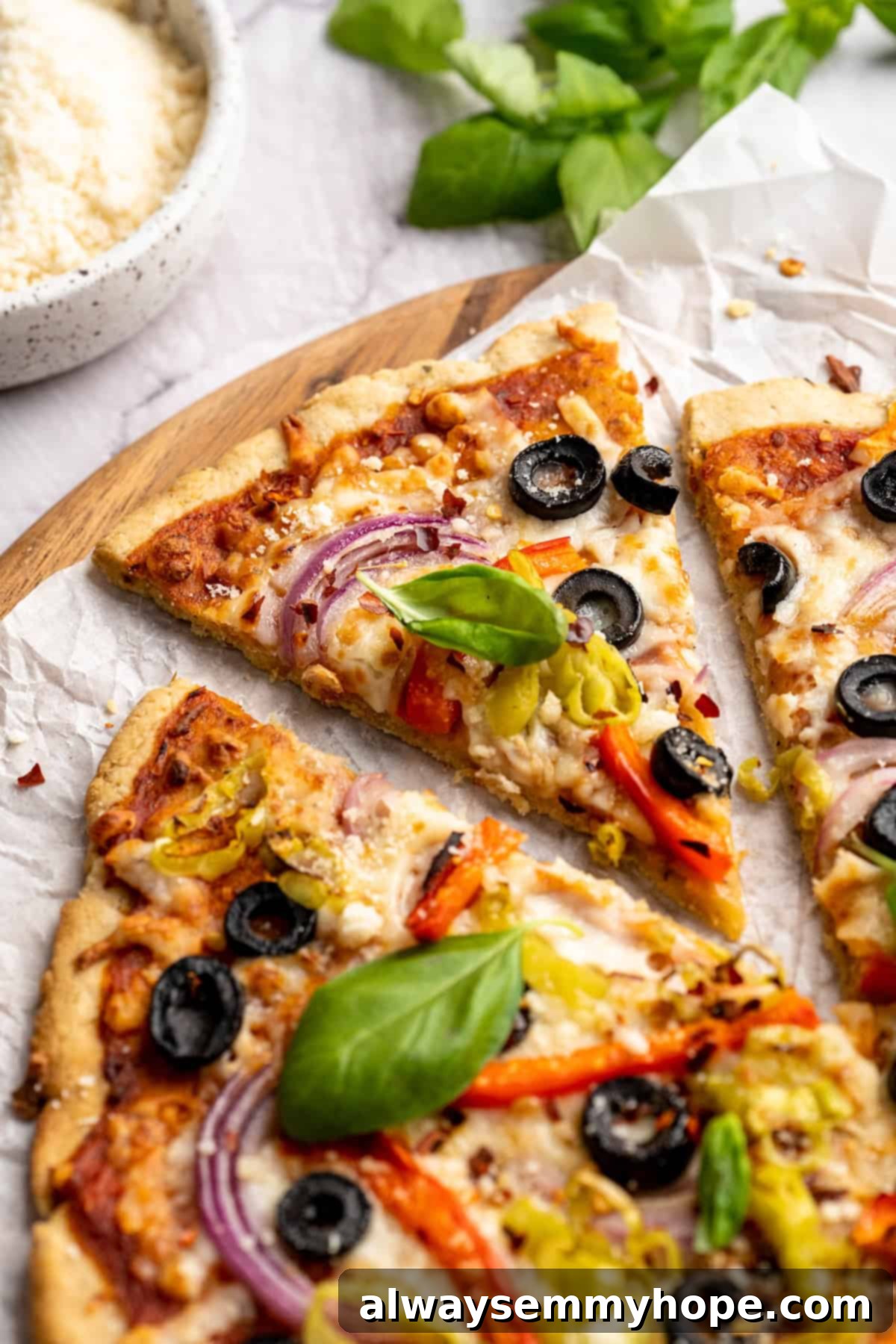 A close-up view of a whole vegetable pizza with almond flour crust, showcasing its appealing texture and fresh toppings.