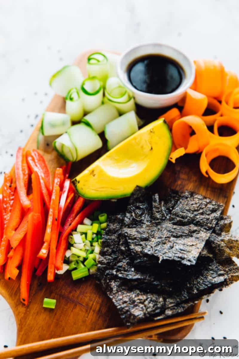 Avocado, peppers, cucumber, carrots and seaweed on a wooden board. 