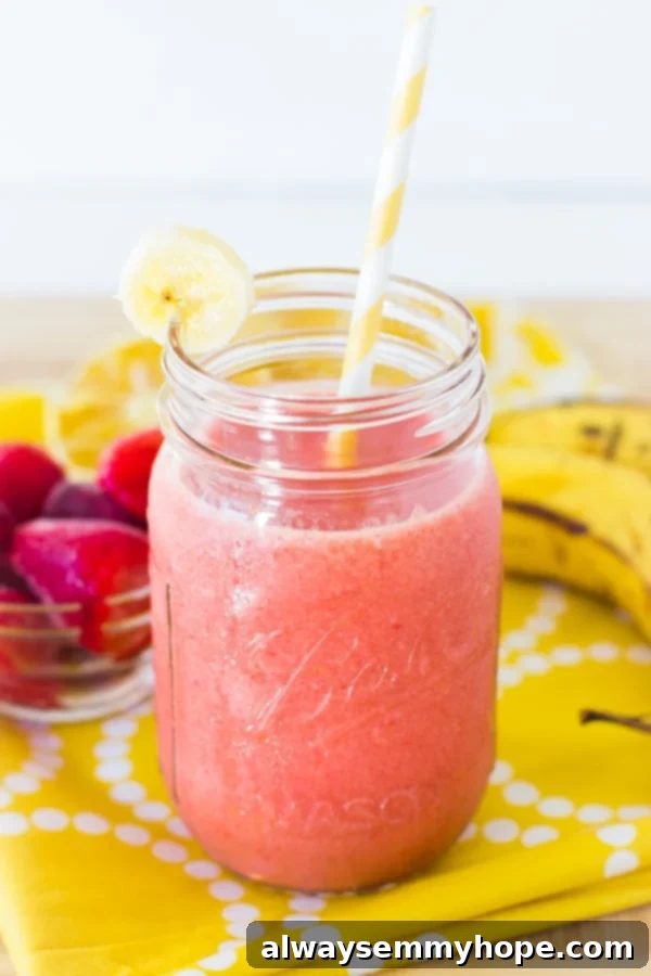 Strawberry banana smoothie in a mason jar with a straw, a perfect quick and healthy refreshment.