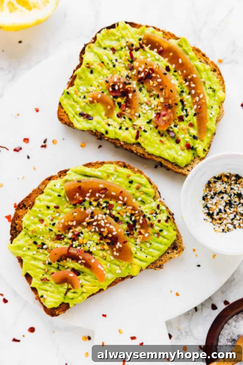 Gourmet avocado toast topped with vibrant pickled red onions and everything bagel seasoning, perfect for a quick breakfast