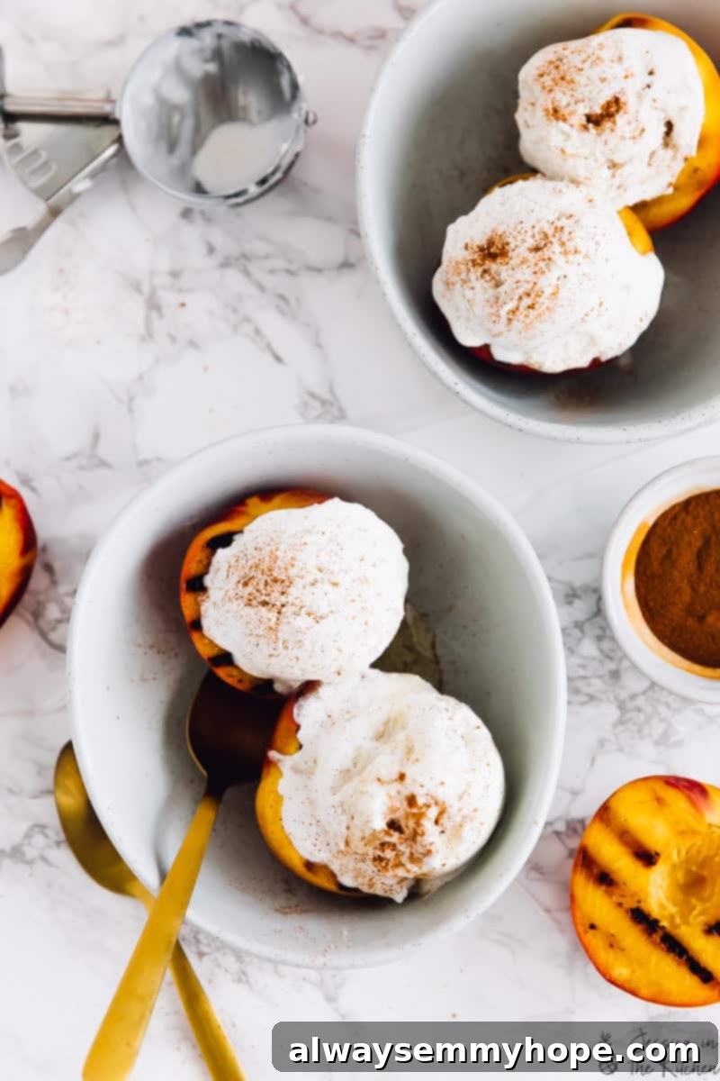 Juicy grilled peaches are sweet, smoky, and the perfect summer treat topped with vegan coconut ice cream! It takes minutes on a hot grill. Overhead view of grilled peaches and ice cream in bowls, next to one half of a grilled peach.