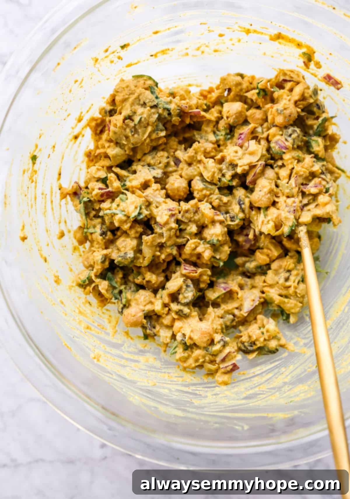 curried chickpea salad fully mixed in a bowl, ready to be served