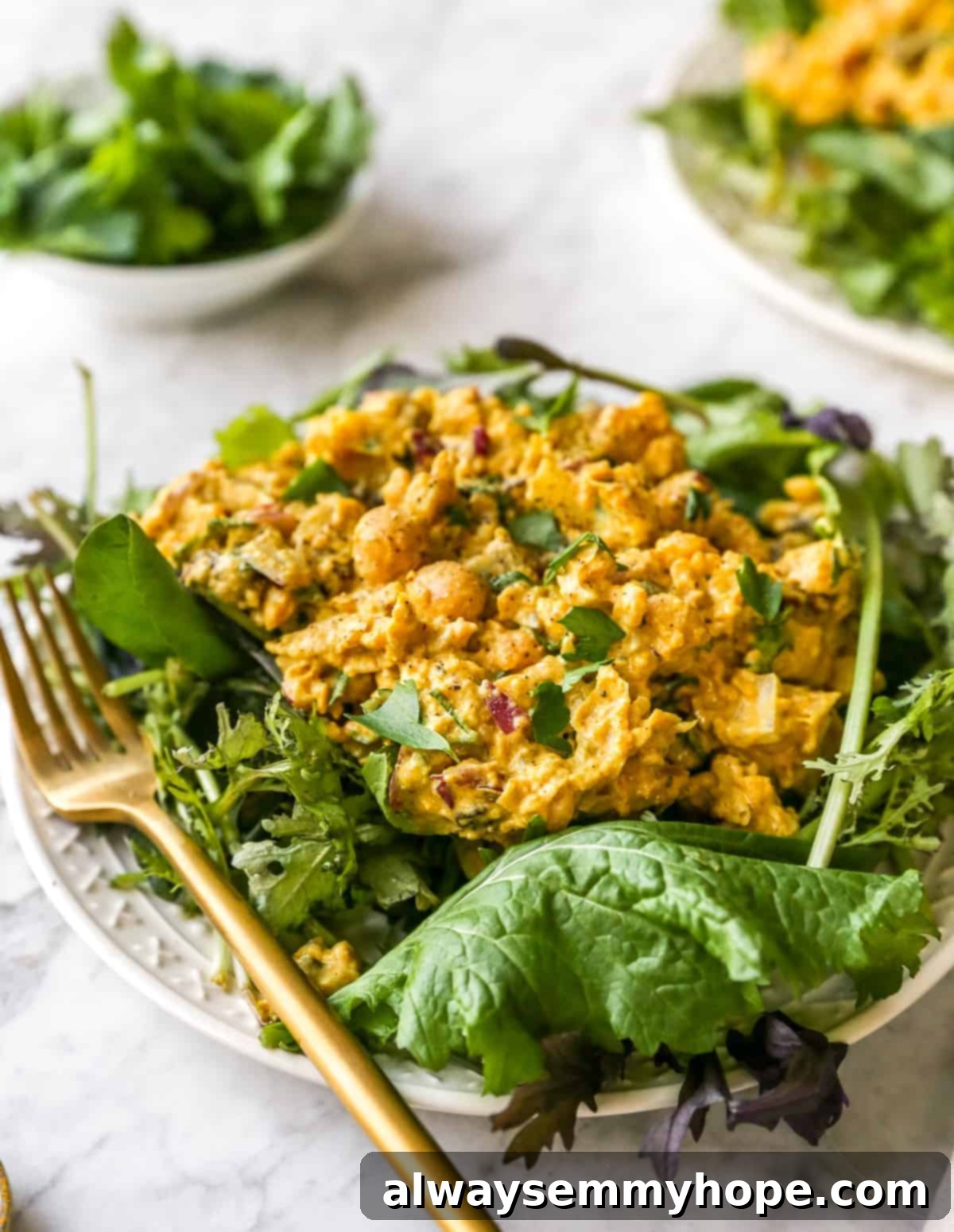 close up shot of curried chickpea salad beautifully plated, showcasing its texture and presentation