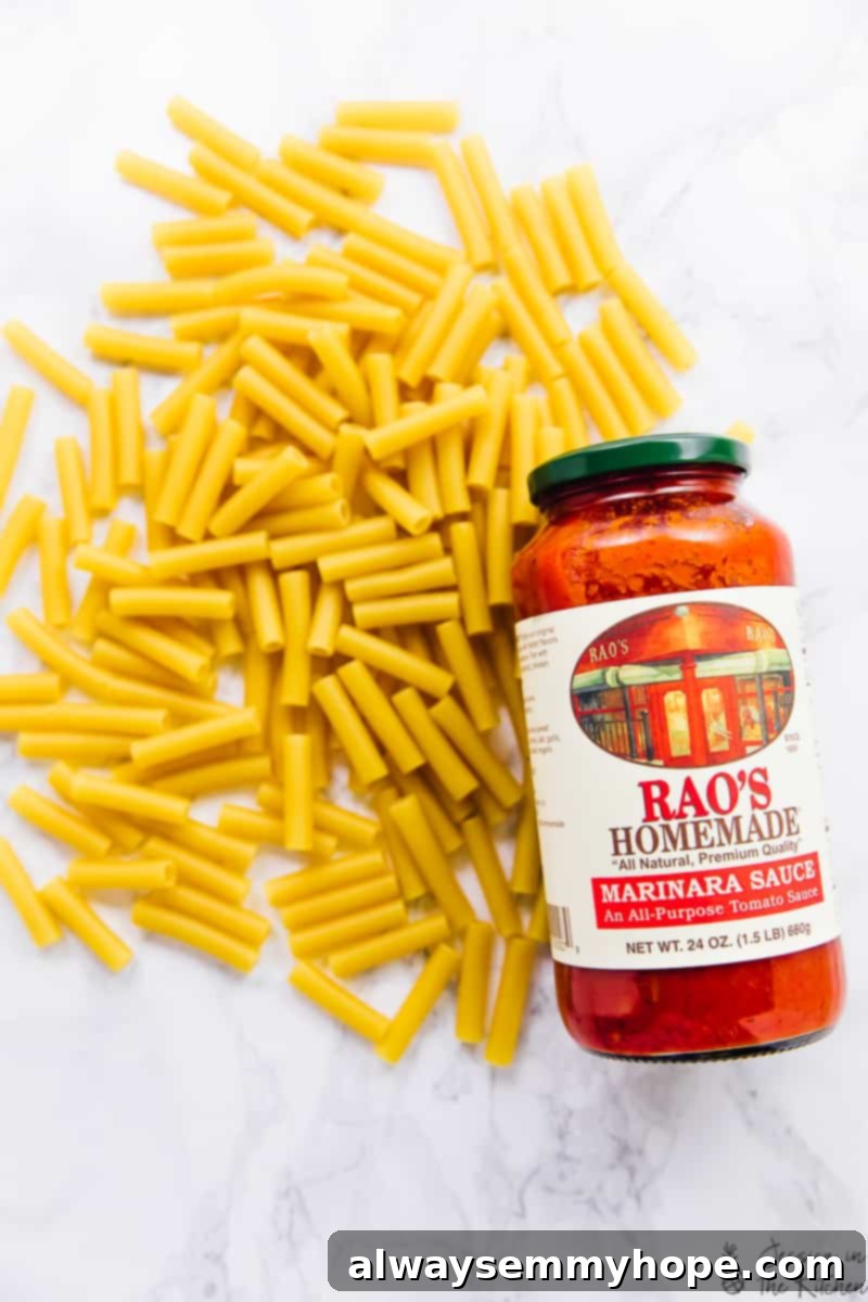 Top down shot of dry ziti pasta with a bottle of Rao's Homemade tomato sauce, emphasizing the key ingredients.