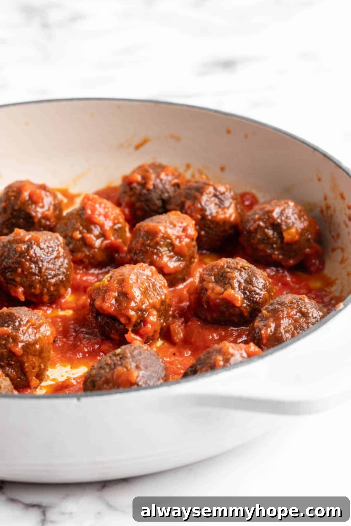 Plant-Powered Spaghetti & Meatballs 11 Vegan meatballs being cooked in marinara