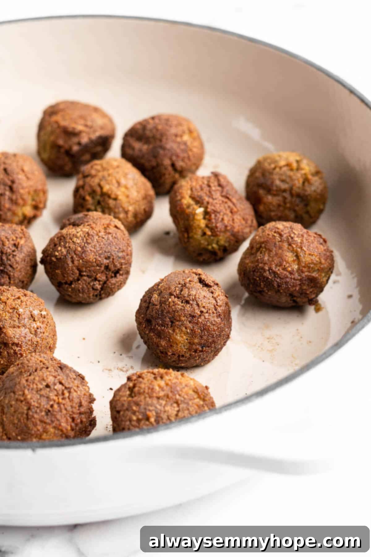 Plant-Powered Spaghetti & Meatballs 3 Vegan meatballs cooking in pan