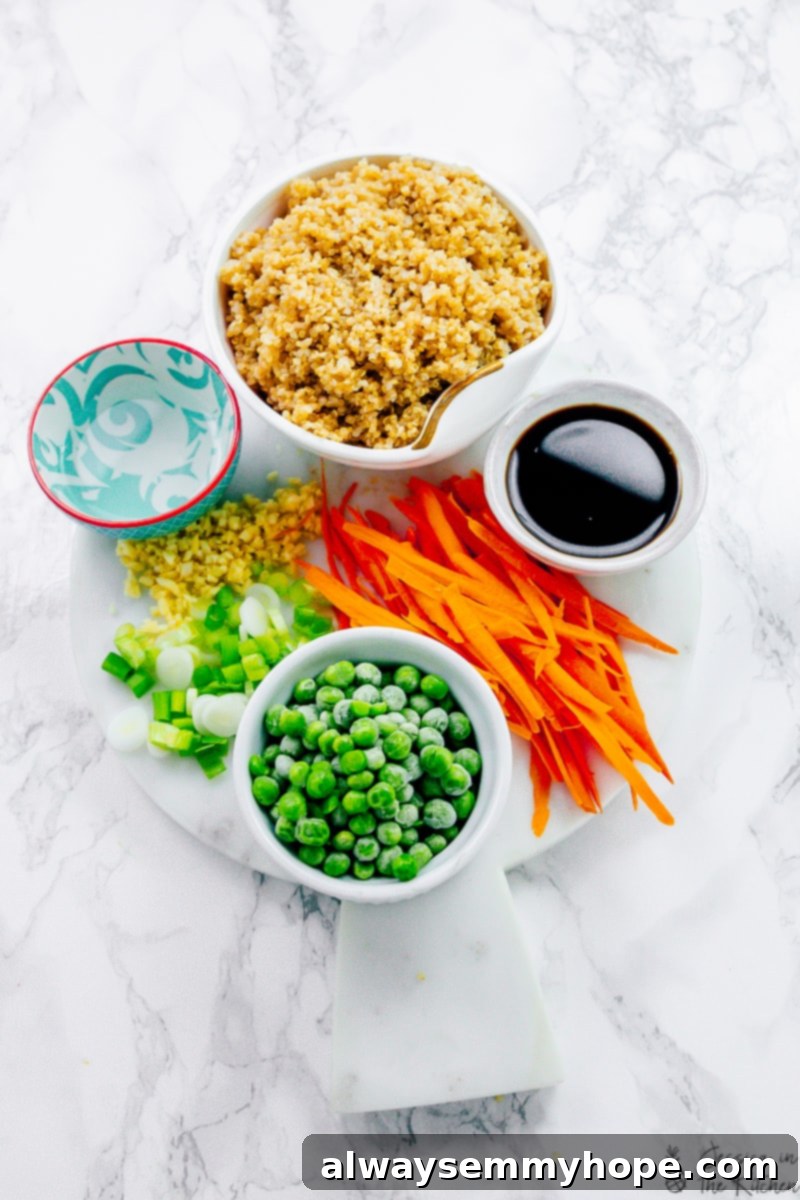 Overhead view of fresh ingredients for quinoa fried rice laid out on a cutting board