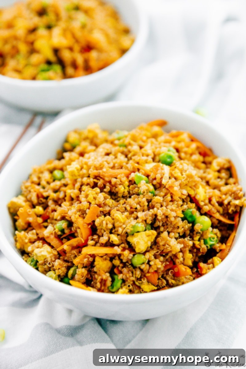 Two bowls of vegan quinoa fried rice with tofu scramble, ready to be eaten