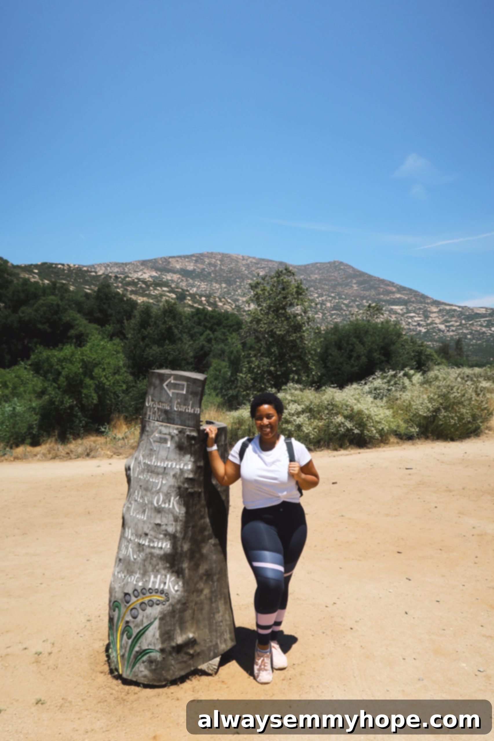 Jessica standing by a tree stump at Rancho La Puerta, a top wellness resort.
