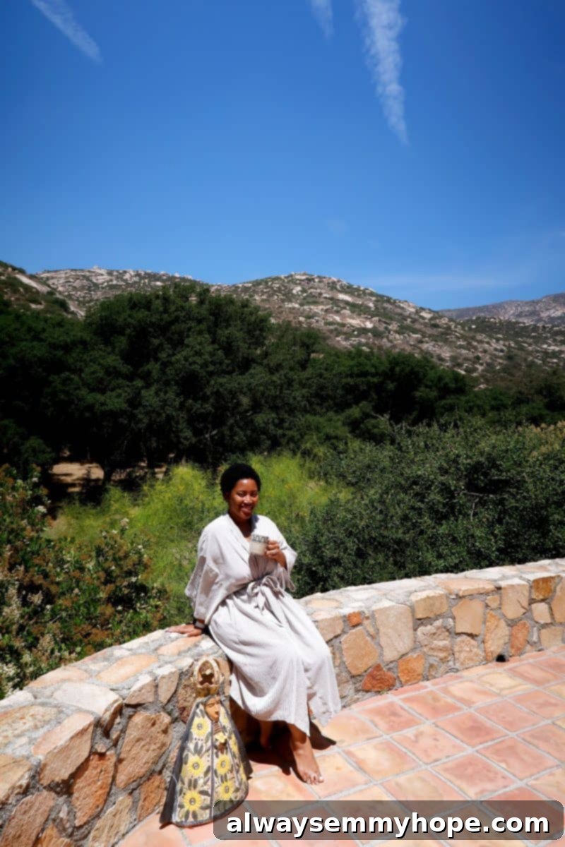 Jessica sitting outside, holding a mug at Rancho La Puerta.