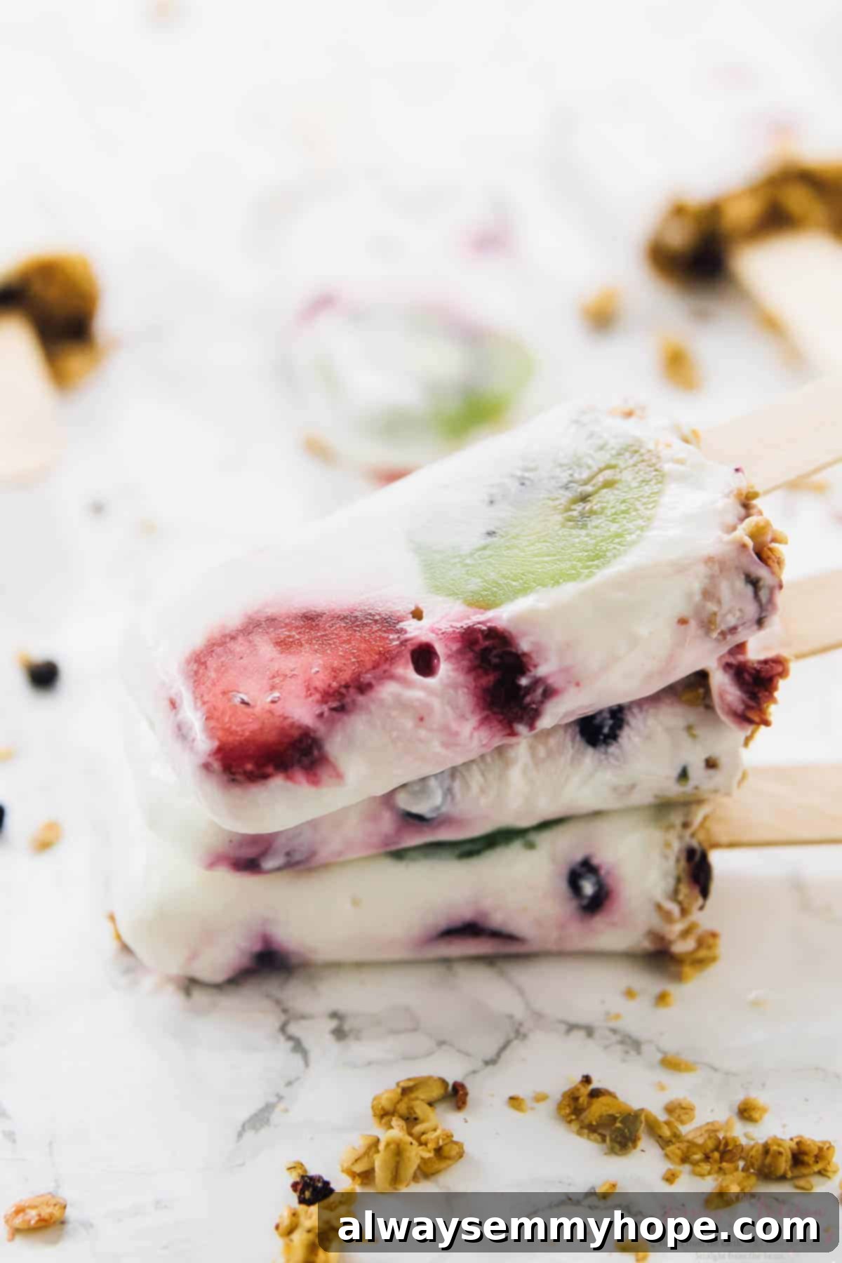 Top 15 Vegan Frozen Treats for Summer Relief 13 A stack of yogurt parfait popsicles on a table top.