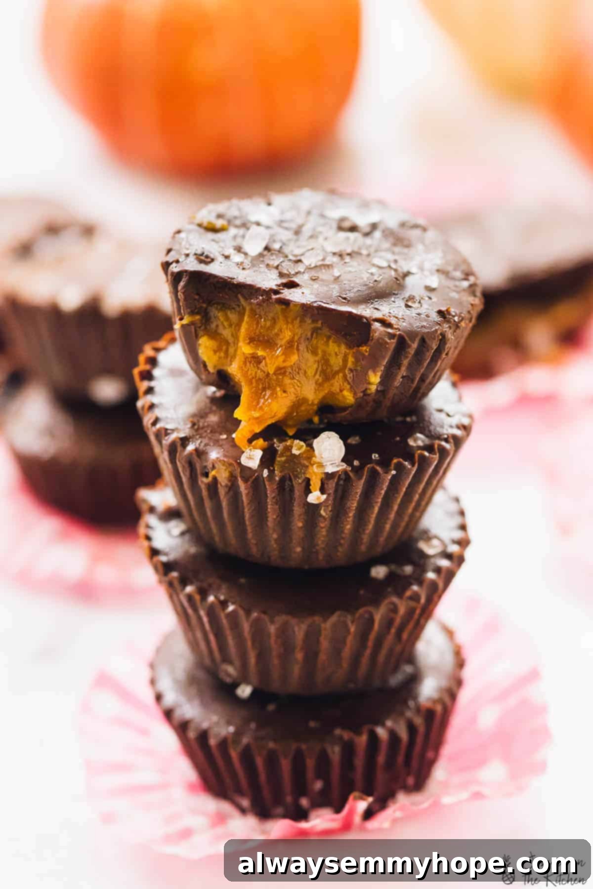 Top 15 Vegan Frozen Treats for Summer Relief 15 A stack of chocolate cups on a pink wrapper.