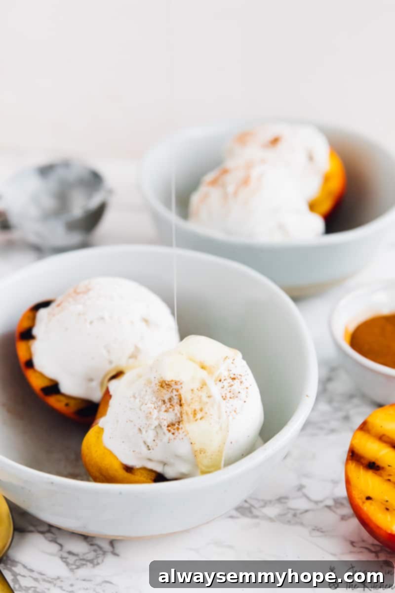 Top 15 Vegan Frozen Treats for Summer Relief 2 Grilled peaches and coconut ice cream in a bowl with maple syrup drizzled on top.