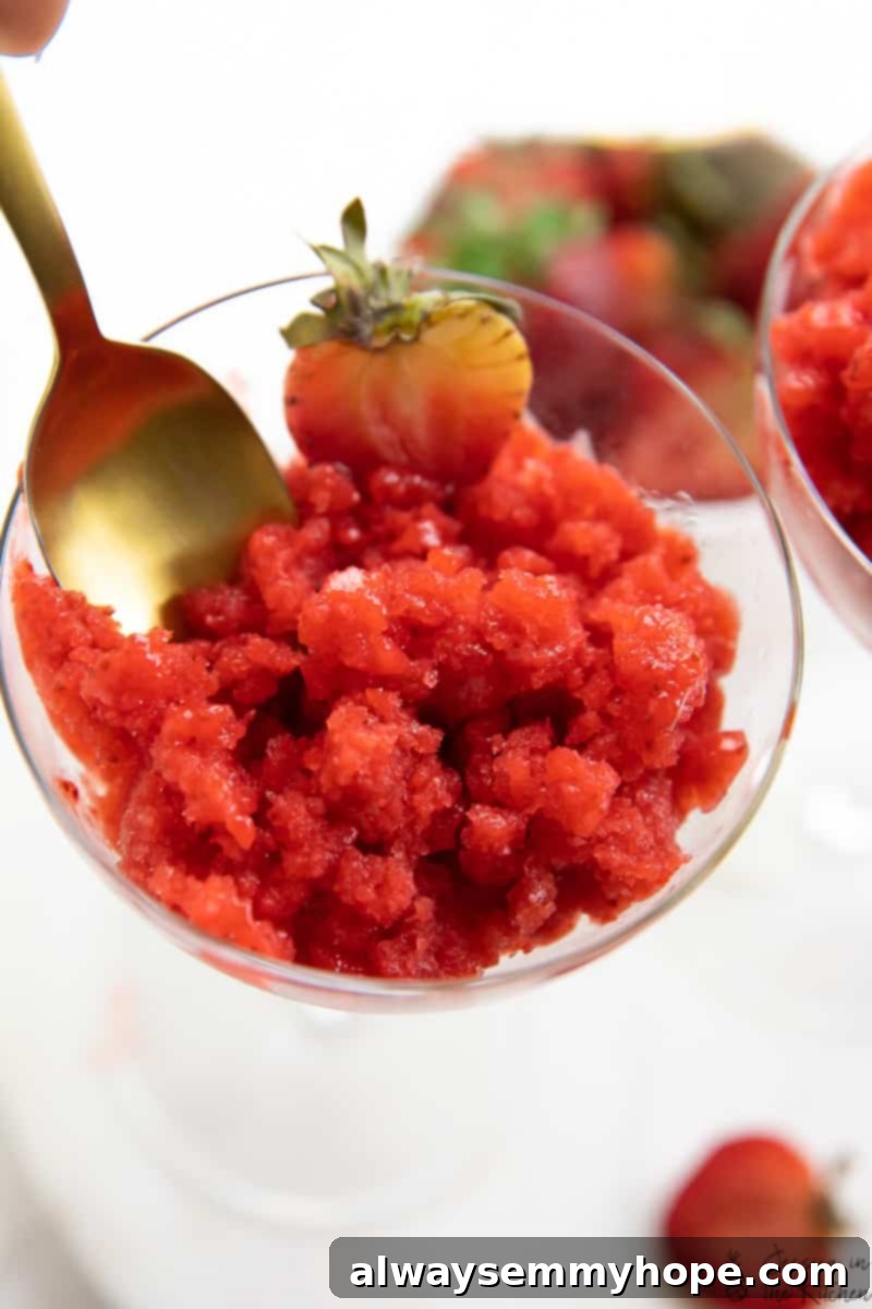 Top 15 Vegan Frozen Treats for Summer Relief 4 A spoon scooping out some strawberry granita form a glass.