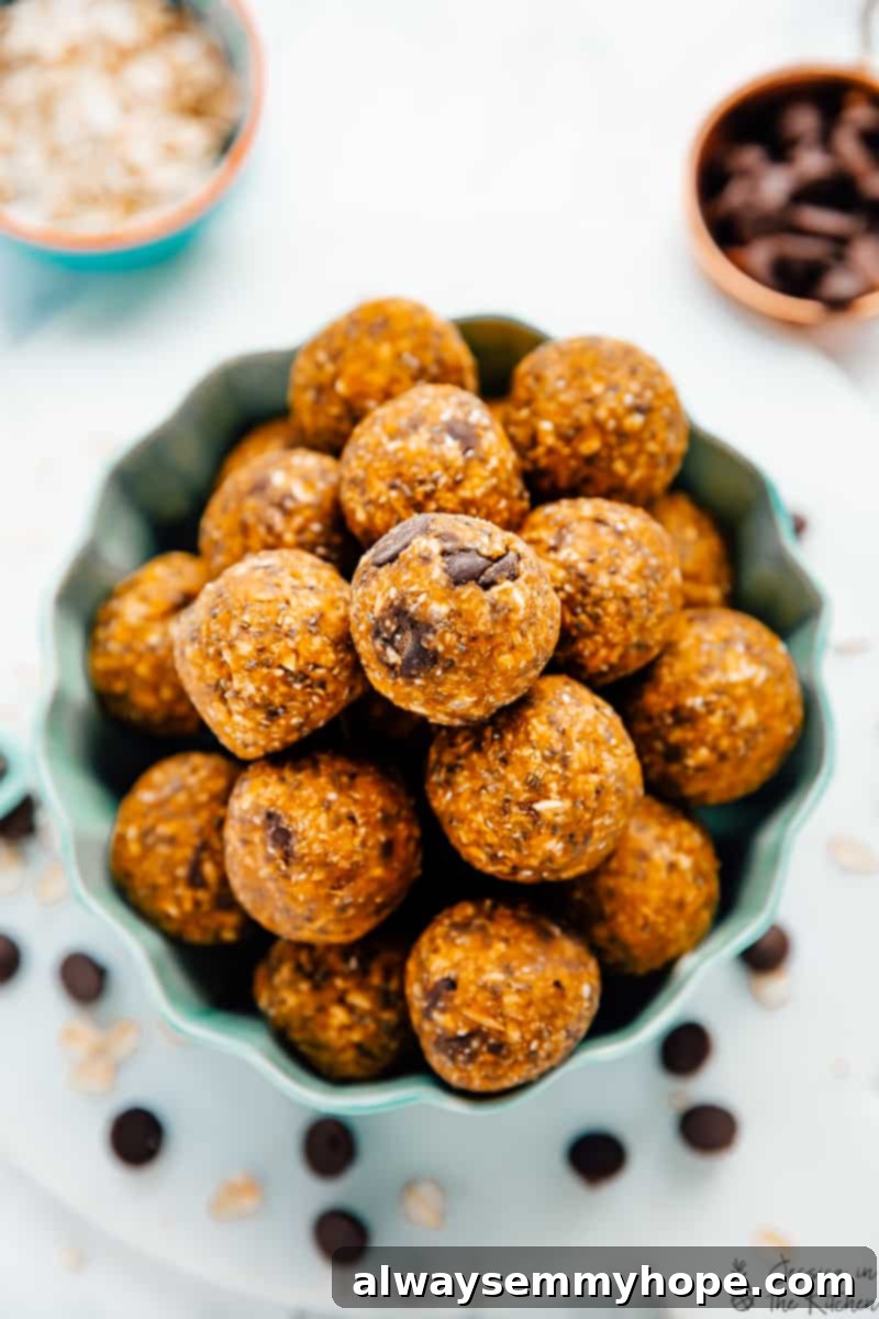 No-bake pumpkin protein balls take just 10 minutes to make! Vegan, gluten-free, and filled with spice. Perfect for breakfast or a snack! Pumpkin energy bites in a bowl in a flat lay photo.
