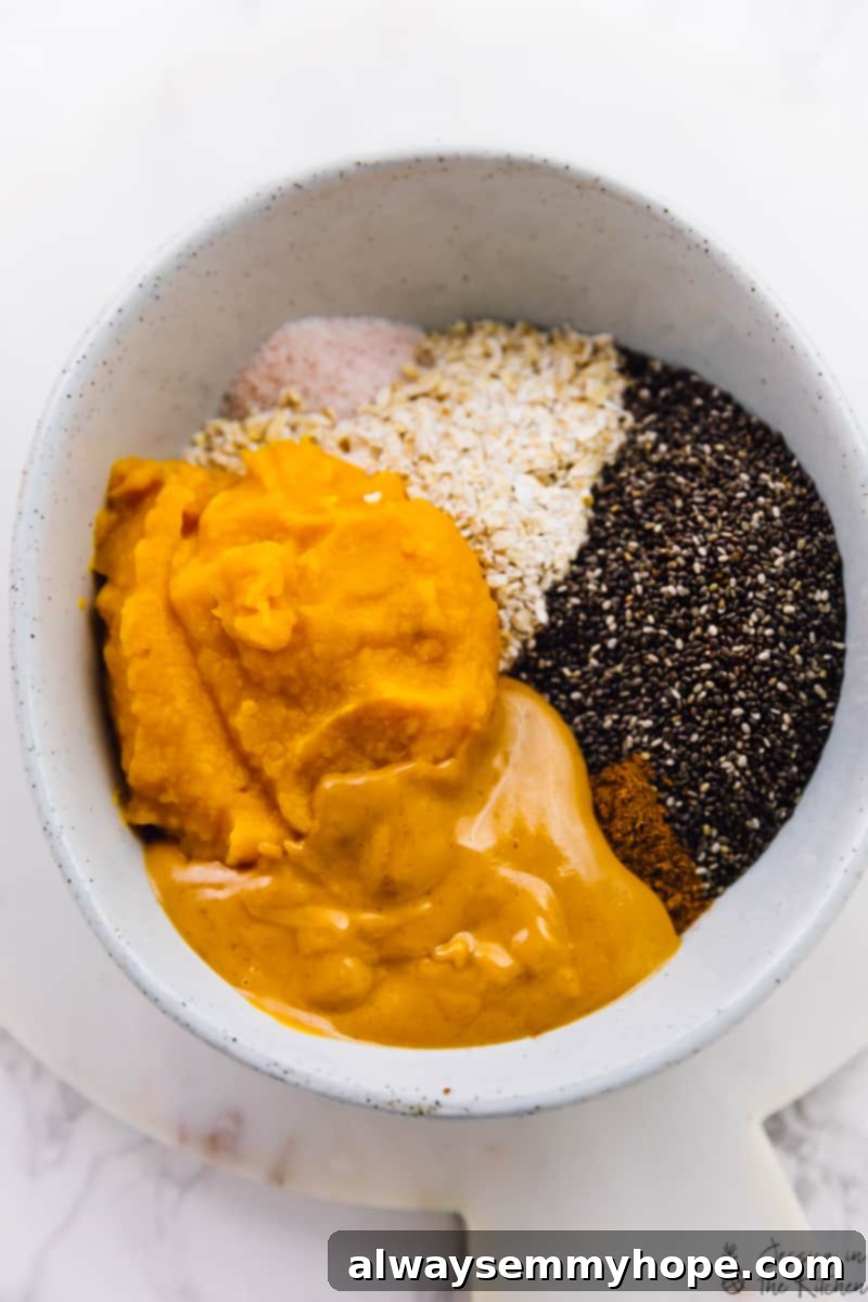 No-bake pumpkin protein balls take just 10 minutes to make! Vegan, gluten-free, and filled with spice. Perfect for breakfast or a snack! Ingredients for pumpkin protein balls combined in a bowl.