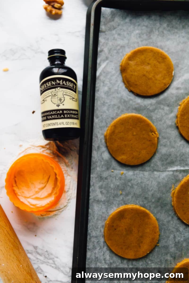 Top down view of pumpkin spice cookies on a baking sheet. 