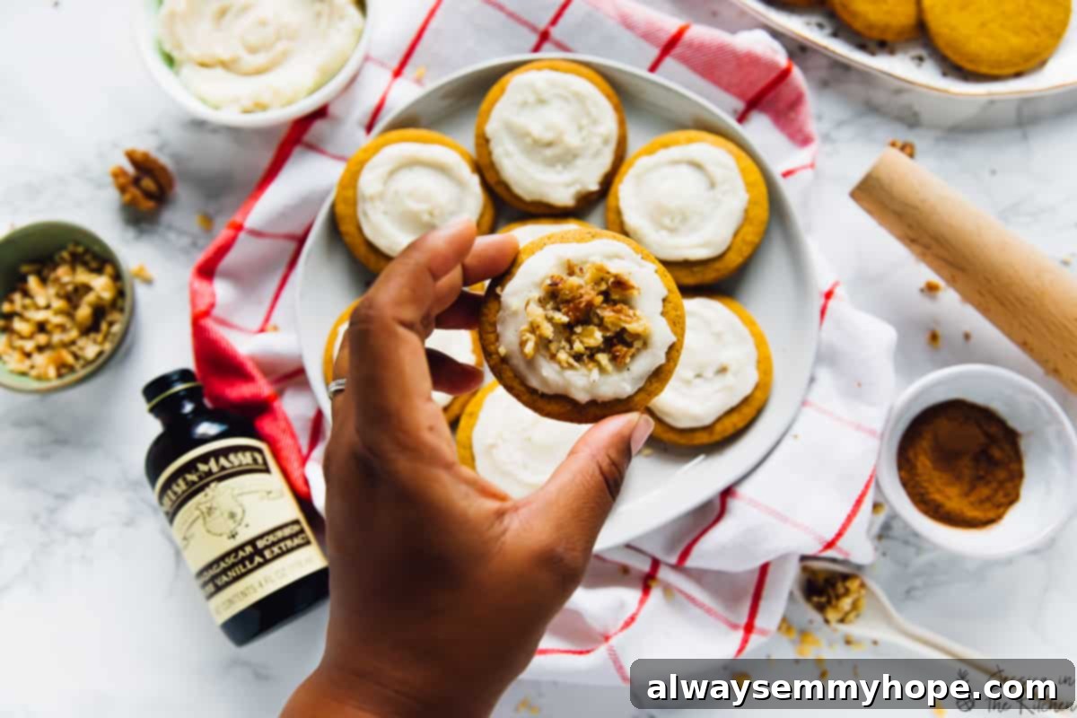 A hand holding a pumpkin spice cookie. 