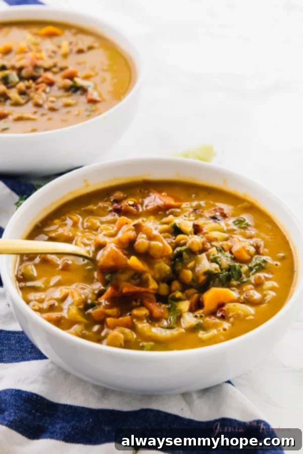 Spoon scooping out some delicious lentil soup from a rustic bowl.