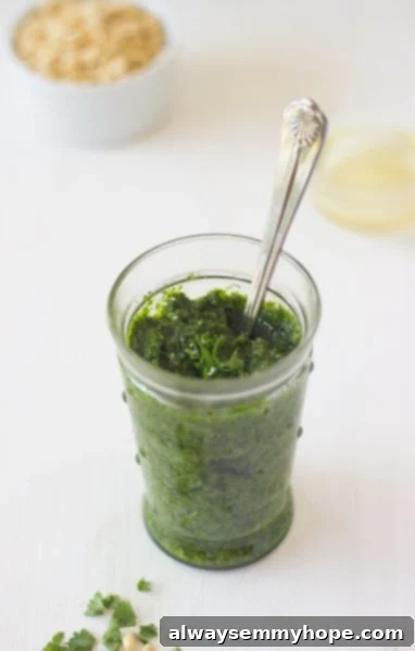 Freshly made parsley pesto stored in a glass jar.