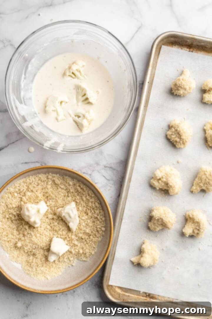 If you love your heat with a side of sweet, these mango habanero cauliflower wings will blow your tastebuds away. An easy crowd-pleaser! Overhead view showing process of dredging cauliflower florets