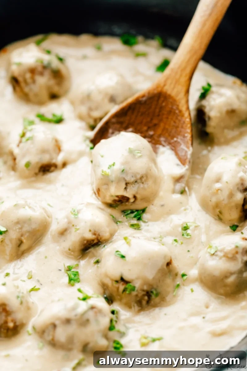 Vegan Swedish meatballs served in a skillet, generously garnished with fresh parsley